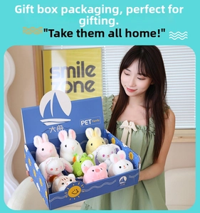 Detail view of plush animal dolls gift set in a blue box held by a person