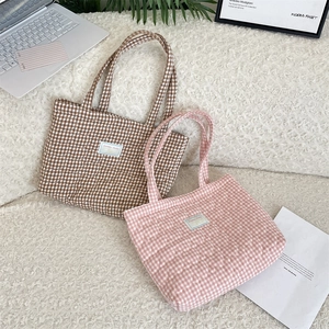Gros plan de sacs cabas en coton matelassé à motifs à carreaux rose et marron