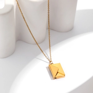 Detailed view of an openable gold envelope locket pendant on a delicate chain