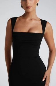 Detail of elegant black square neck knitted dress featuring a slim-fit tailored silhouette