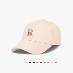 Beige baseball cap with sequined R letter and wide curved brim for a slim face look