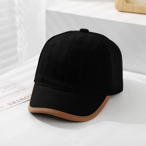 Close-up of black mesh baseball cap with brown piped brim on minimalist white display stand