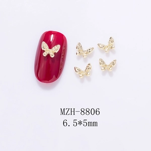 Golden 3D hollow butterfly nail charms MZH-8806 with 6.5x5mm detail on red fake nail
