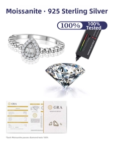 Macro detail of pear cut moissanite ring with beaded band and GRA certificate