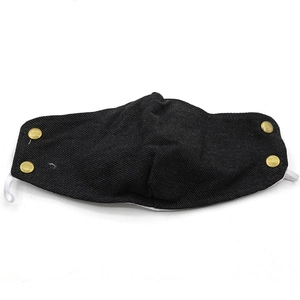 Detail view of the black denim fabric texture and golden decorative buttons on the winter mask
