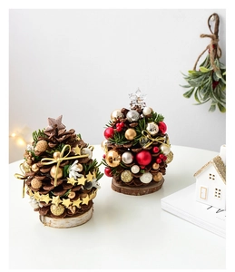 Close-up of mini natural pine cone Christmas trees with golden stars and wooden bases