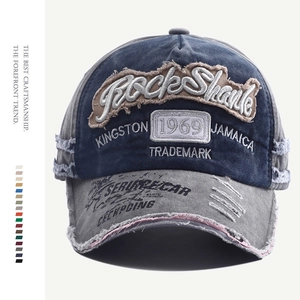 Detailed embroidery on vintage washed denim baseball cap with Rock Shark lettering
