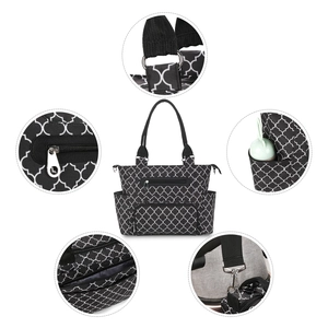 Detail view of 7-piece diaper bag set showing hardware hooks, zippers, and side pockets