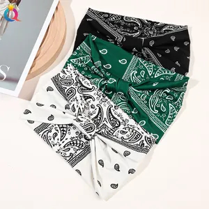 Three-piece set of wide paisley knotted headbands in black, green, and cream colors