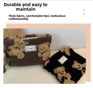 Detail of plush bear pattern makeup bags with zipper and Time To Party label