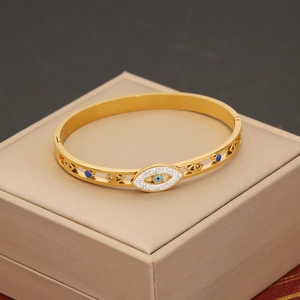 Gold stainless steel snake bracelet with evil eye design and pavé rhinestones