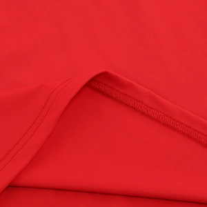Close-up detail of high-quality red knit fabric stitching and smooth texture on long dress