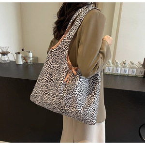 Detail of leopard print canvas tote bag featuring stylish bow-knot straps on shoulder