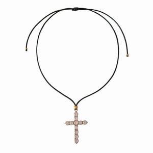Close-up of zircon-encrusted cross pendant on black adjustable braided rope chain