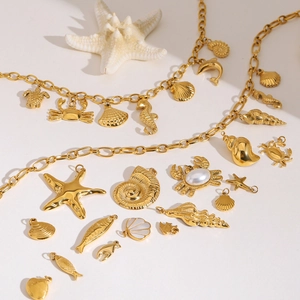 Golden ocean charms including starfish, shells, and crabs for beach jewelry DIY