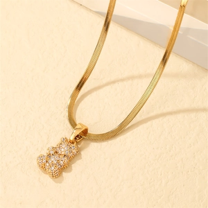 Detailed view of a gold-plated teddy bear pendant with pavé-set zircons on a snake chain