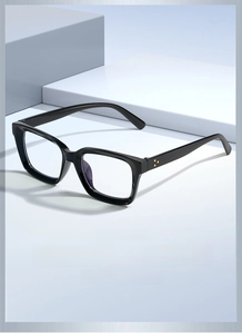 Detail of black square frame glasses with yellow triple star rivets on geometric background
