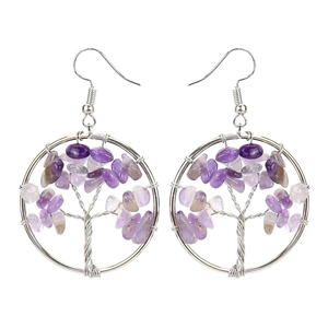 Detailed macro view of handmade tree of life wire wrapped earrings with purple amethyst stones