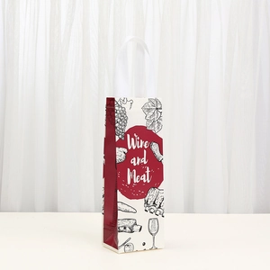 Kraft wine gift bag with red vineyard prints and Wine and Meat text on a white table