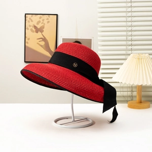 French style red wide brim straw hat with black ribbon and golden M logo detail