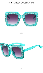 Close-up of mint green square sunglasses featuring sparkling rhinestones and gradient lenses