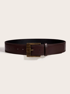 Detail of dark brown leather wide belt with a rectangular antique brass buckle