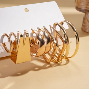 Detail view of 10-piece gold geometric earring set with circular and triangular designs