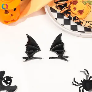 Pair of black bat wing hair clips with detailed stitching for Halloween hair accessories