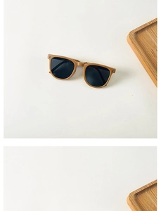 Detailed top view of foldable tan matte square sunglasses for kids on white surface