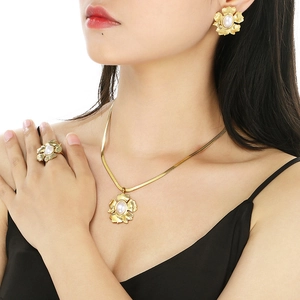 Close-up of a gold double-layer floral jewelry set with pearls on a model neck and hand