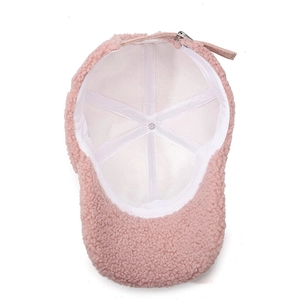 Pink sherpa baseball cap with rhinestone bow detail showing internal structure and lining