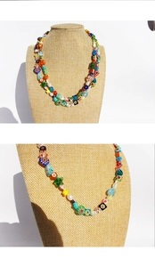 Detail of handmade colorful floral beaded necklace with heart shapes and pearls