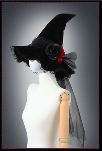 Detail of gothic witch hat with dark velvet, lace veil, and red faux floral accents