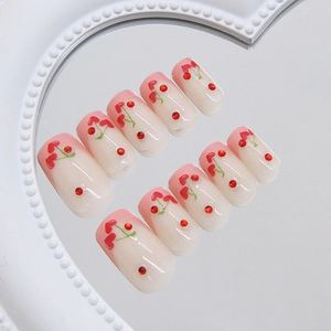 Pink French ombre press-on nails with red heart cherry patterns and crystal rhinestones