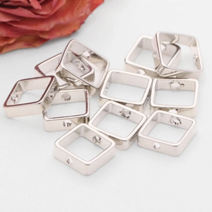 Macro view of silver square metal bead covers for DIY jewelry making and connection