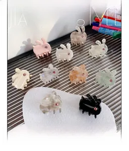 Detailed set of 10 mini acetate rabbit hair claws with sparkling pink rhinestone accents