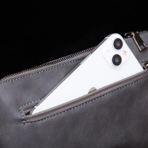 Detail of the high-quality dark gray matte leather bag featuring a smooth metal zipper pocket