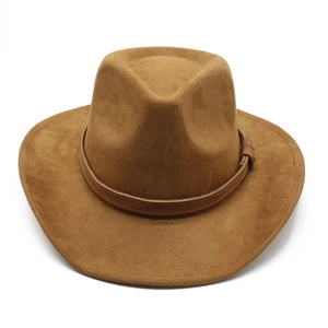 Top view of a brown suede cowboy hat with a classic dented crown and leather buckle band