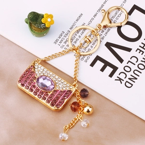 Detailed view of luxury envelope keychain with purple crystals and elegant beaded tassels