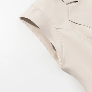 Detail of premium beige fabric stitching on the blazer sleeve and underarm seam