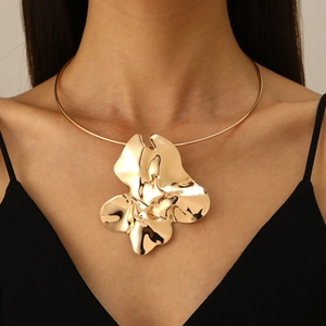 Irregular metal flower pendant collar necklace in glossy gold finish on model