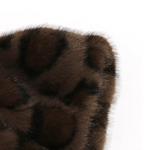 Macro shot showing soft leopard print faux fur texture and fluffy synthetic fibers