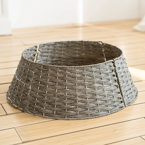 Deep brown woven Christmas tree collar with vintage texture on a natural wood floor