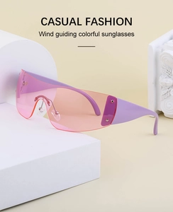 Pink lens Y2K wrap-around sunglasses with star rivets on a white geometric stand