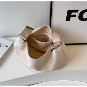 Top view of cream-colored tote bag showing spacious interior pocket and smooth texture