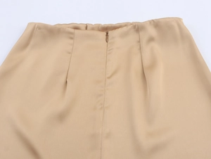 Detailed back view of champagne satin skirt featuring a seamless invisible zipper closure