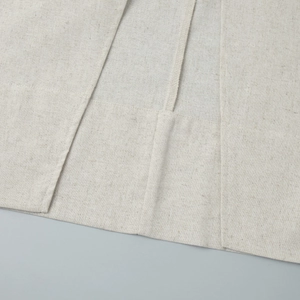 Macro shot of high-quality light beige cotton linen fabric with detailed stitching