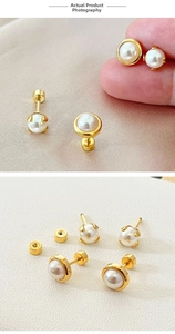 Detailed view of 6mm pearl earrings with 18K gold screw-back studs on silk fabric