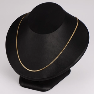 Minimalist 2mm flat gold link chain necklace displayed on a black neck mannequin stand