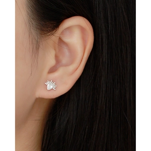 Close-up of S925 silver teardrop zircon earring with sunburst design on model's ear